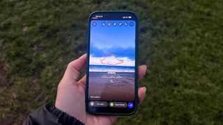 iPhone 17 screen showing Strava stats as a sticker overlaying a photo of the beach