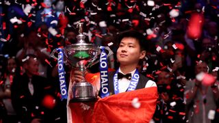 Zhao Xintong of China poses for a photo with the Halo World Snooker Championship trophy