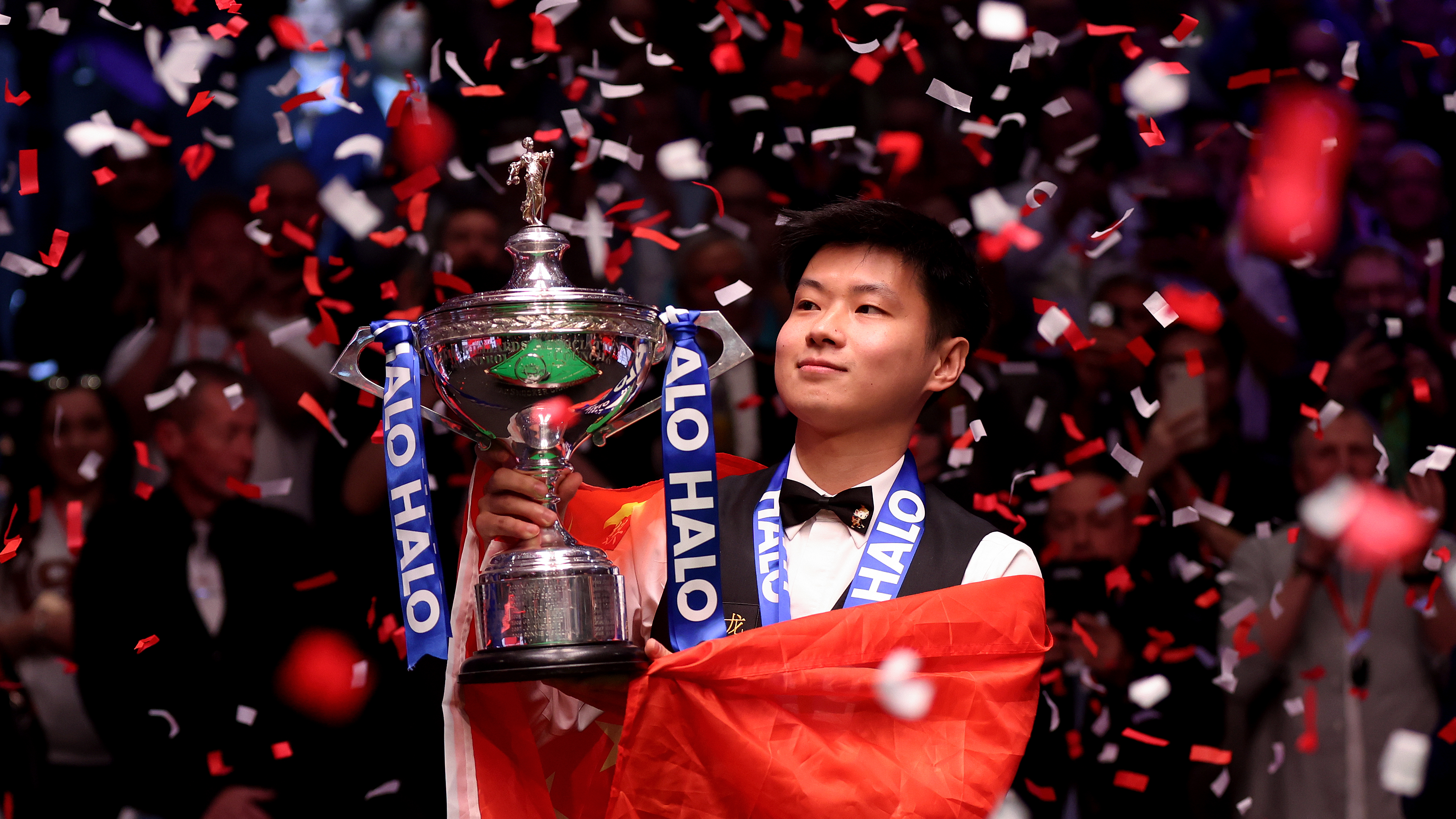 Zhao Xintong of China poses for a photo with the Halo World Snooker Championship trophy