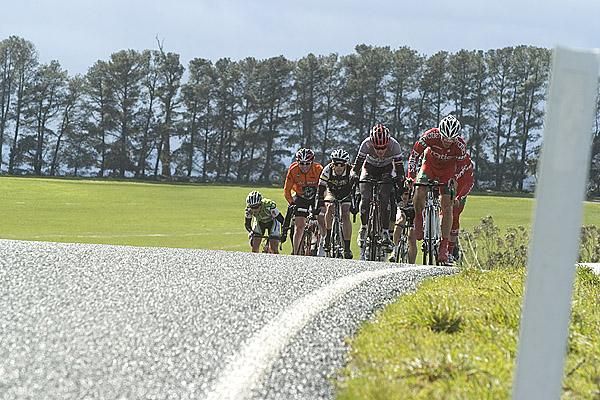The third group struggle up a climb in windy weather near Cressy.