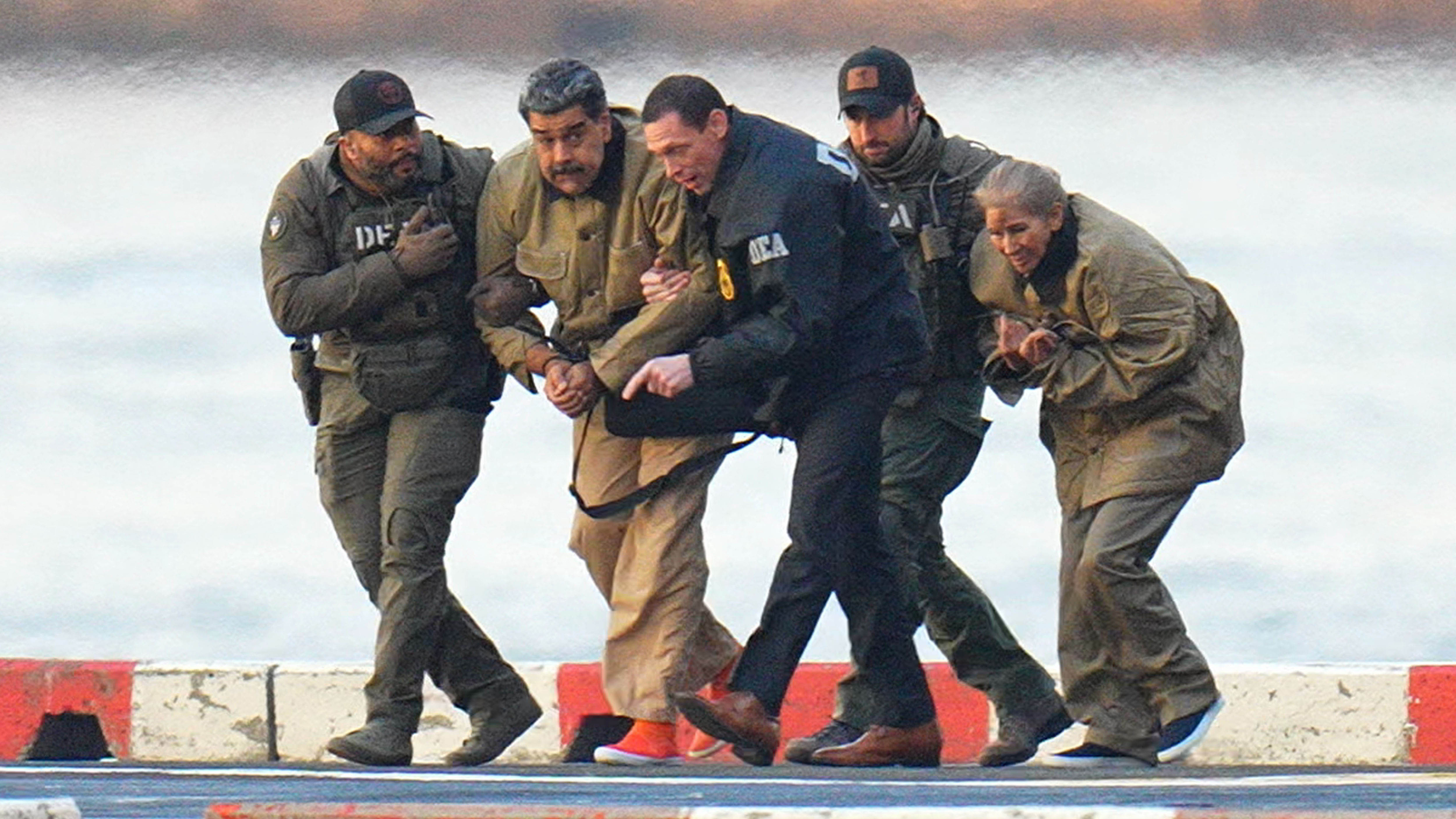 Nicolas Maduro and his wife, Cilia Flores, are seen in handcuffs after landing at a Manhattan helipad, escorted by heavily armed Federal agents as they make their way into an armored car en route to a Federal courthouse in Manhattan.
