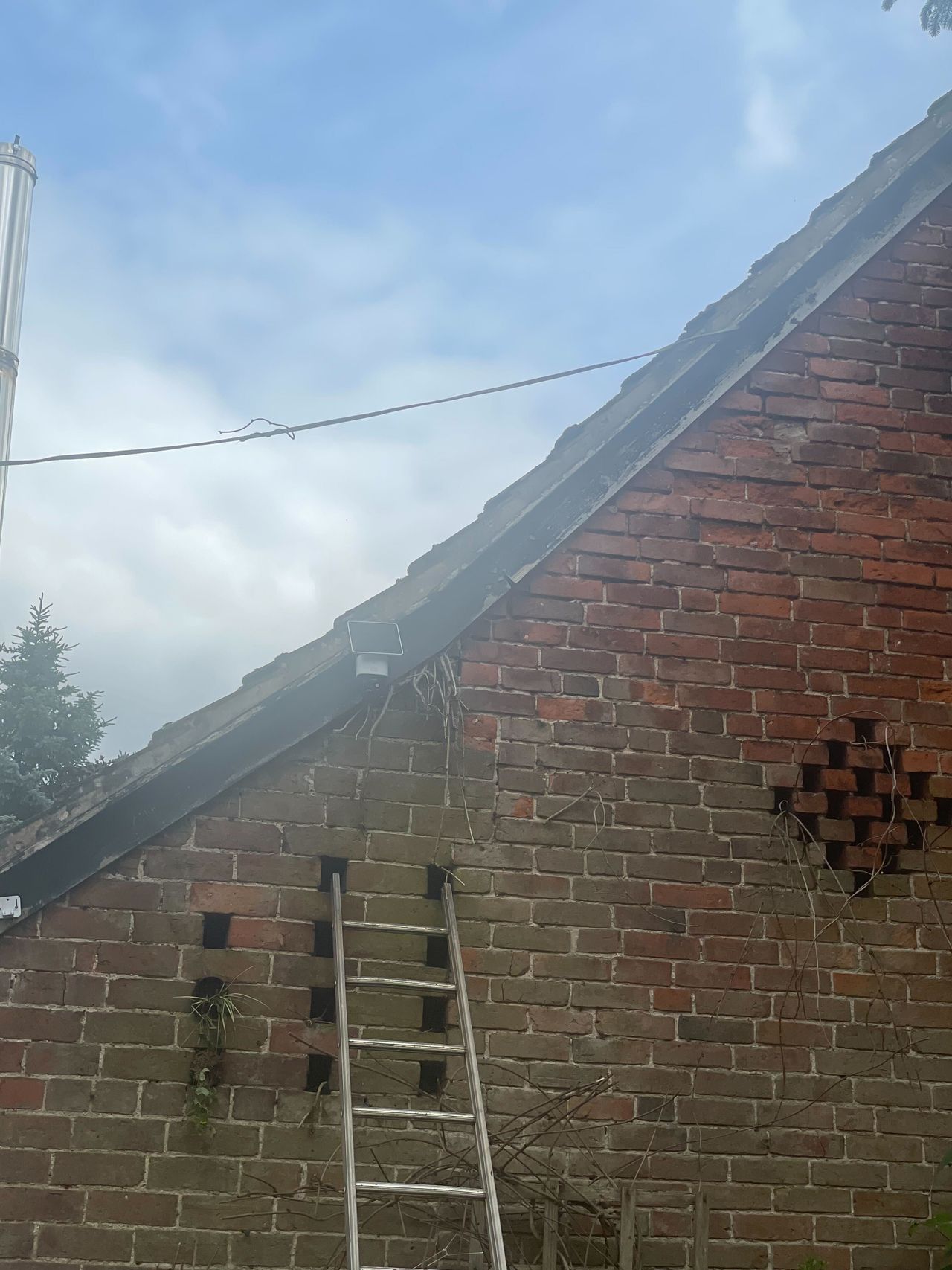 A security camera with solar panel on a wall