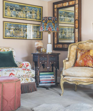 French-style living room with white arm chairs and orange pillows