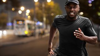 Man running in city at night