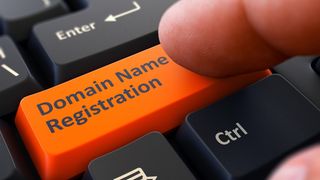 Finger Presses Orange Button Domain Name Registration on Black Keyboard Background. Closeup View