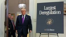 Donald Trump arrives in the Roosevelt Room of the White House to announce environmental deregulations.