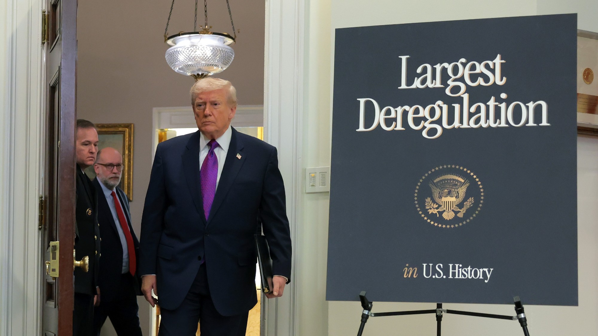 Donald Trump arrives in the Roosevelt Room of the White House to announce environmental deregulations.