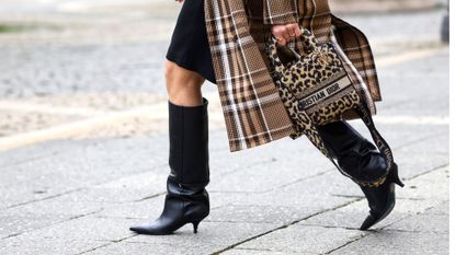 FRANKFURT AM MAIN, GERMANY - JANUARY 18: A leopard print bag by Dior and black knee high boots by Patrizia Pepe as a detail of influencer Simone Adams, seen during the Frankfurt Fashion Week January 2022 on January 18, 2022 in Frankfurt am Main, Germany. (Photo by Streetstyleshooters/Getty Images)