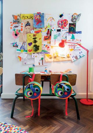 kids desk area with pinboard full of art
