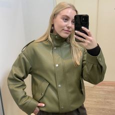 Woman wears green bomber jacket