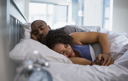 Couple lying in bed together