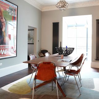 dining room with grey wall and dining table with chairs