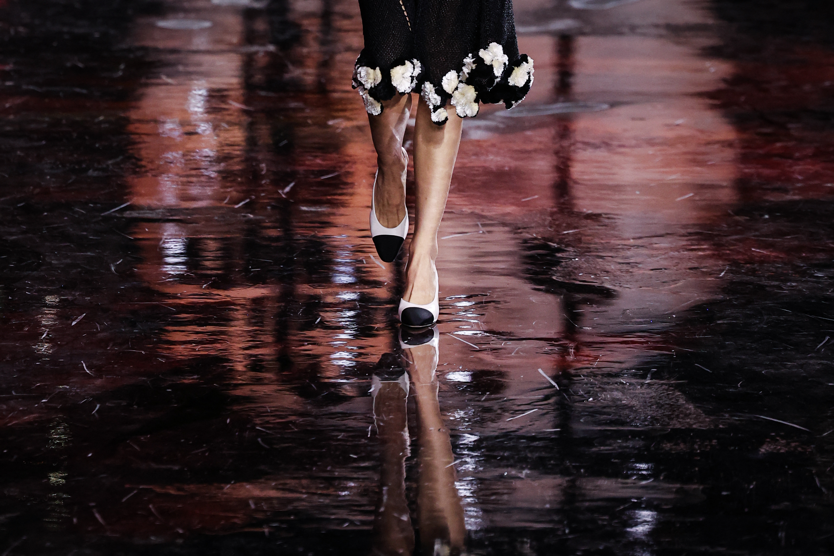 a model on a chanel runway wearing cap toe shoes