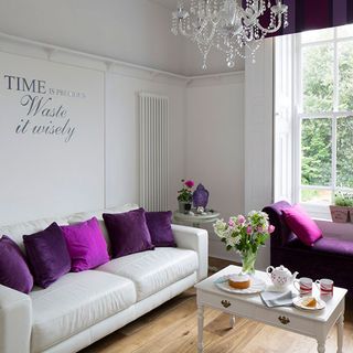living area with white backdrop and arkona harlequin grape velvet bench