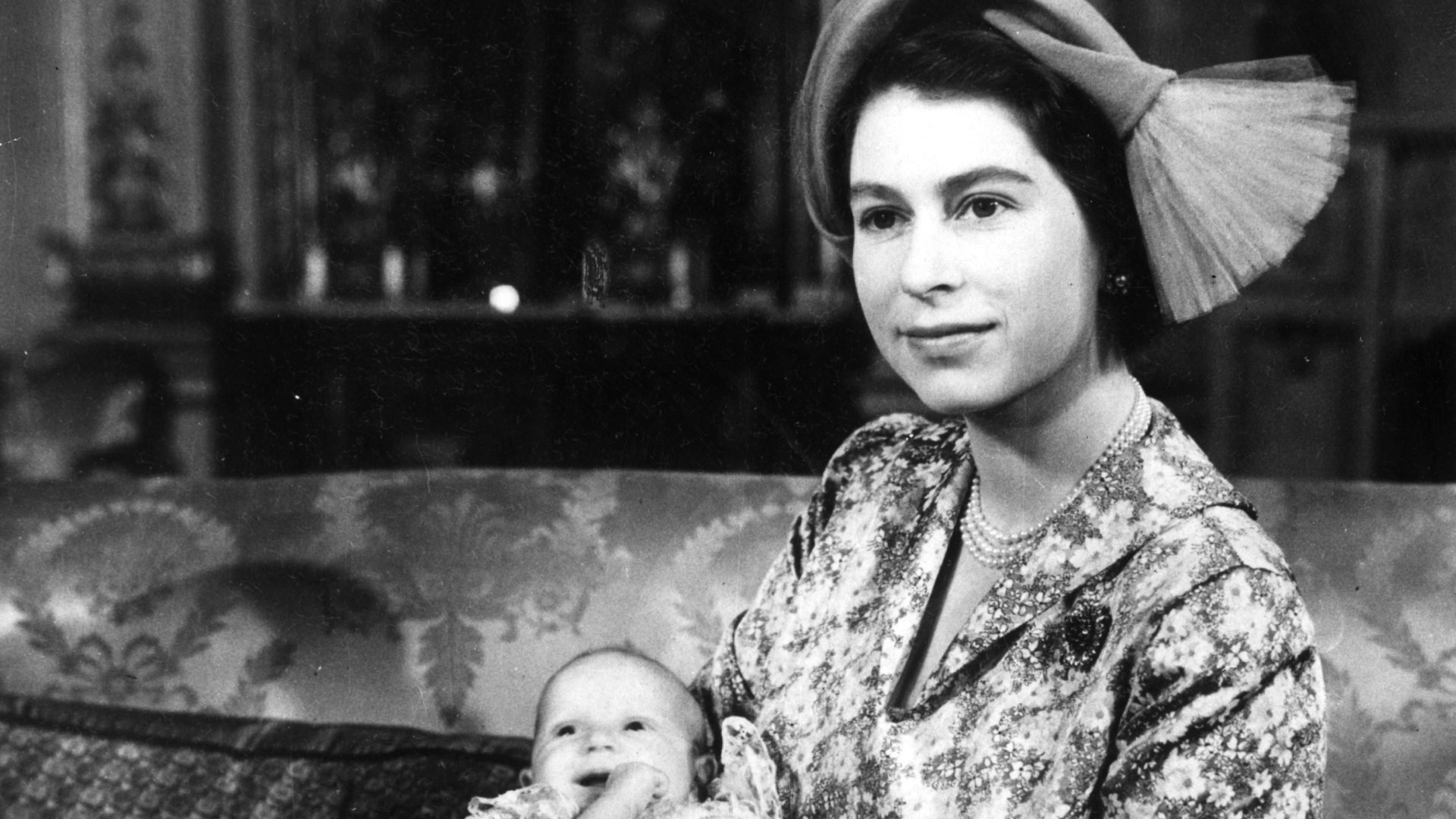 Queen Elizabeth holding Princess Anne on her christening day