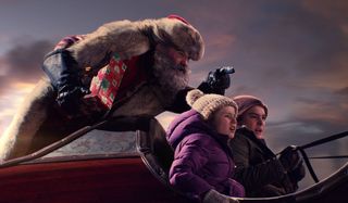 The Christmas Chronicles Kurt Russell riding in the back of the sleigh, giving directions