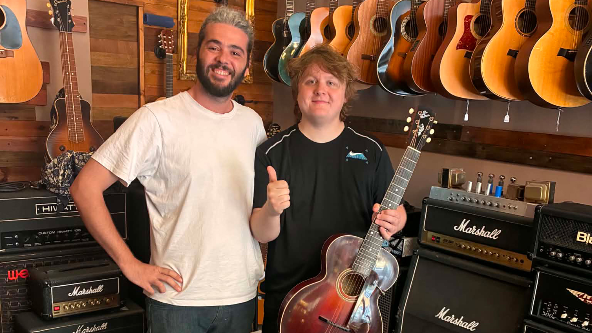 Lewis Capaldi with a vintage Gibson (right) standing next to Play Vintage store owner Andrew Francica