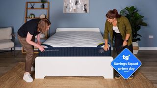 The image shows two mattress testers unboxing the new DreamCloud Classic Hybrid mattress. Inset to the right is a blue Tom's Guide Savings Squad Prime Day badge