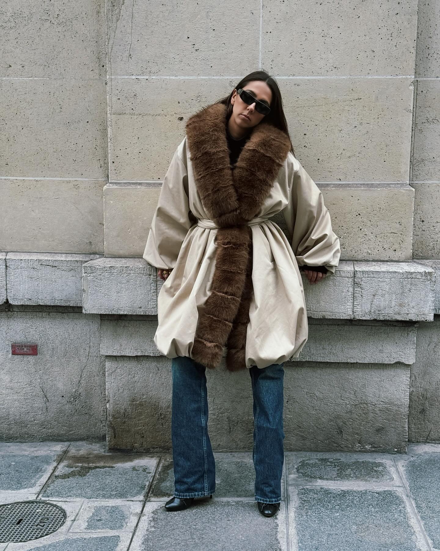 Hanna Marzouki Widlund wearing jeans with a fur trim belted coat.