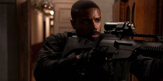 Michael B Jordan clears a hallway with his rifle in Without Remorse.