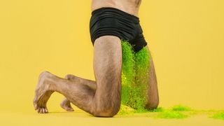 Man in boxers with green stuff coming from his shorts