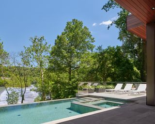 modern infinity pool in a sloping backyard