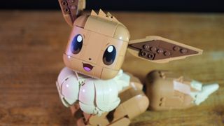 Lego Eevee sat on a wooden table, smiling into the foreground