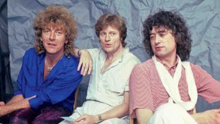 Led Zeppelin’s Robert Plant, John Paul Jones and Jimmy Page posing for a photograph at Live Aid