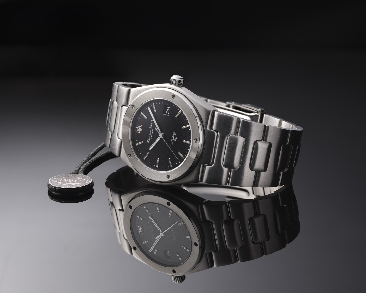 gold and silver IWC watch on a black background