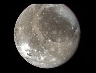 The Jupiter moon Ganymede, the largest satellite in the solar system, as seen by NASAs Voyager 2 spacecraft on July 7, 1979, from a distance of 745,000 miles (1.2 million kilometers).