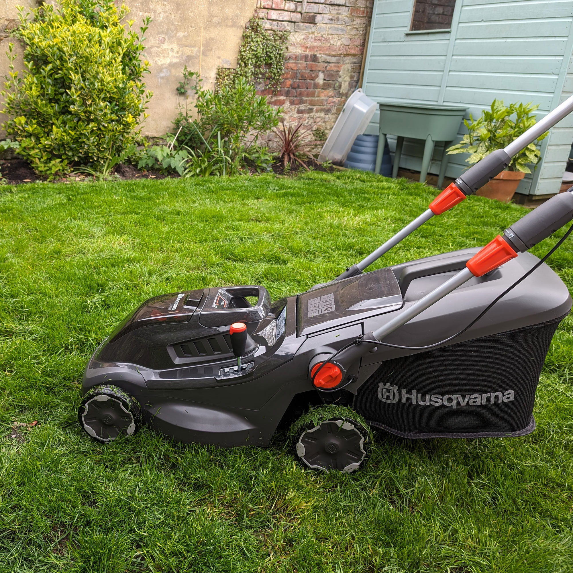 Husqvarna Aspire LC34 P4A mowing a small lawn