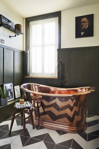copper / copper bath in traditional bathroom with green walls