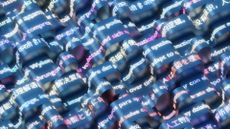 A visualization of AI translation, shown as rippling CGI ribbons with various languages written on them.