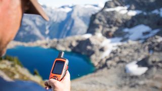 Mountaineer sends a safety message via a satellite communicator