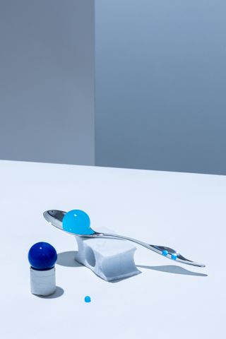 Silver spoon with blue blobs. Spoon made by OIO made with artificial intelligence