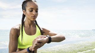 How accurate are fitness trackers: Image shows woman looking at a fitness tracker