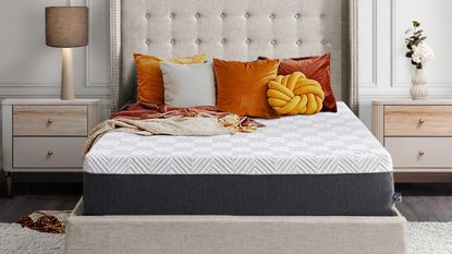 Way Day bedding sales - a Sealy mattress in neutral room with orange and yellow cushions on bed