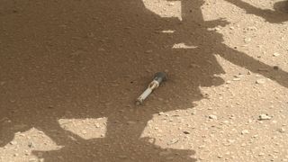 Photo of Mars rover Perseverance's second sample tube on the Martian surface in rover's shadow