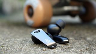 Edifier Neobuds Pro next to a skateboard