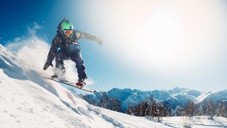 Person snowboarding on a sunny day