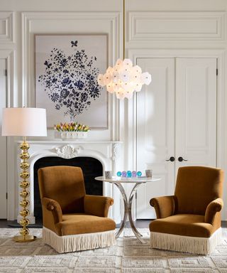 Brown armchairs in a white living room with a games table