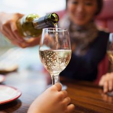 A friend pouring a glass of wine