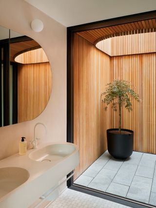 Bathroom and view to outside courtyard at One Park Drive penthouses