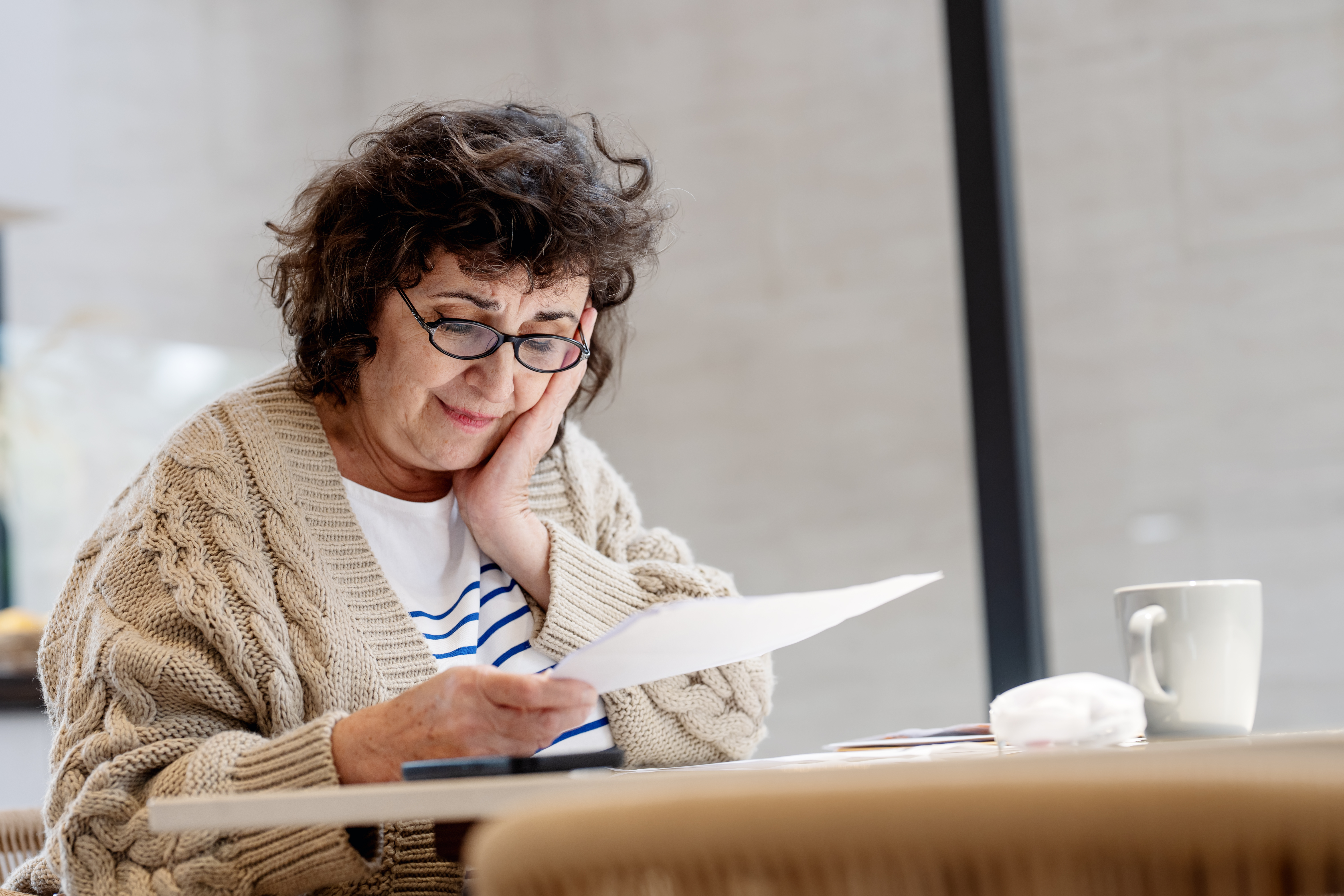 Mature woman managing her finances for flexibility in retirement on her laptop