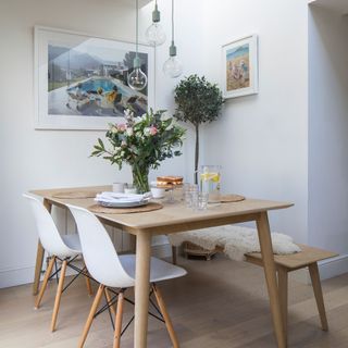 Scandi white dining room with wood dining table and white chairs