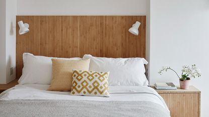 White bed with two pillows and electric blanket atop of mattress