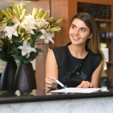 A hotel assistant checking you in