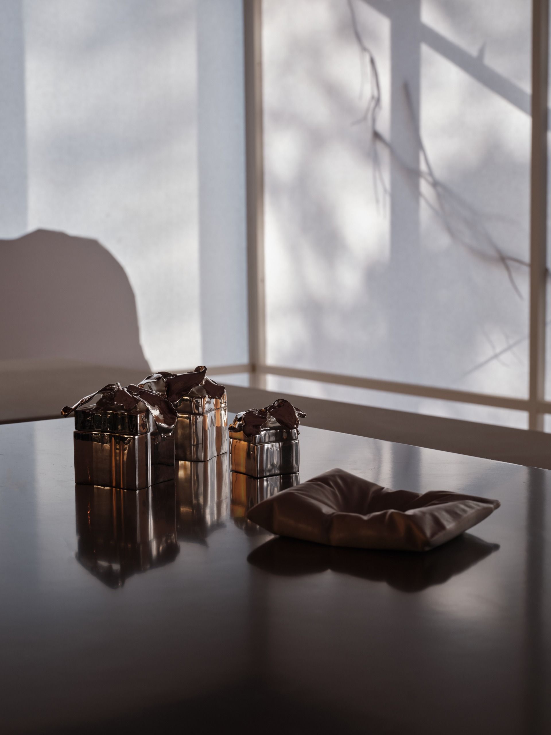 A series of accessories and tableware item featuring a melting-like silhouette with uneven surfaces and inflated volumes.
