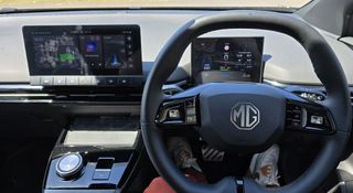 The interior of the MG4, including its small infotainment screen and instrument cluster