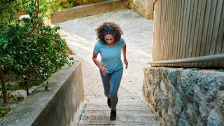 A woman runs up some stairs